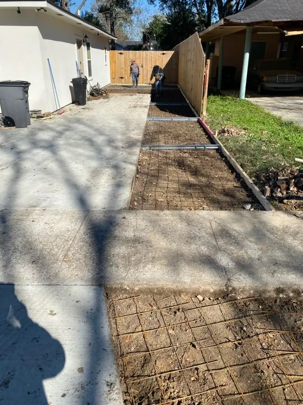 Walkway forms and reinforcement beside a house