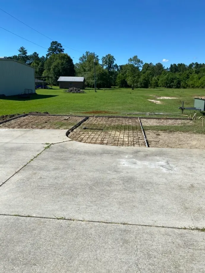 Reinforced extension beside an existing concrete driveway