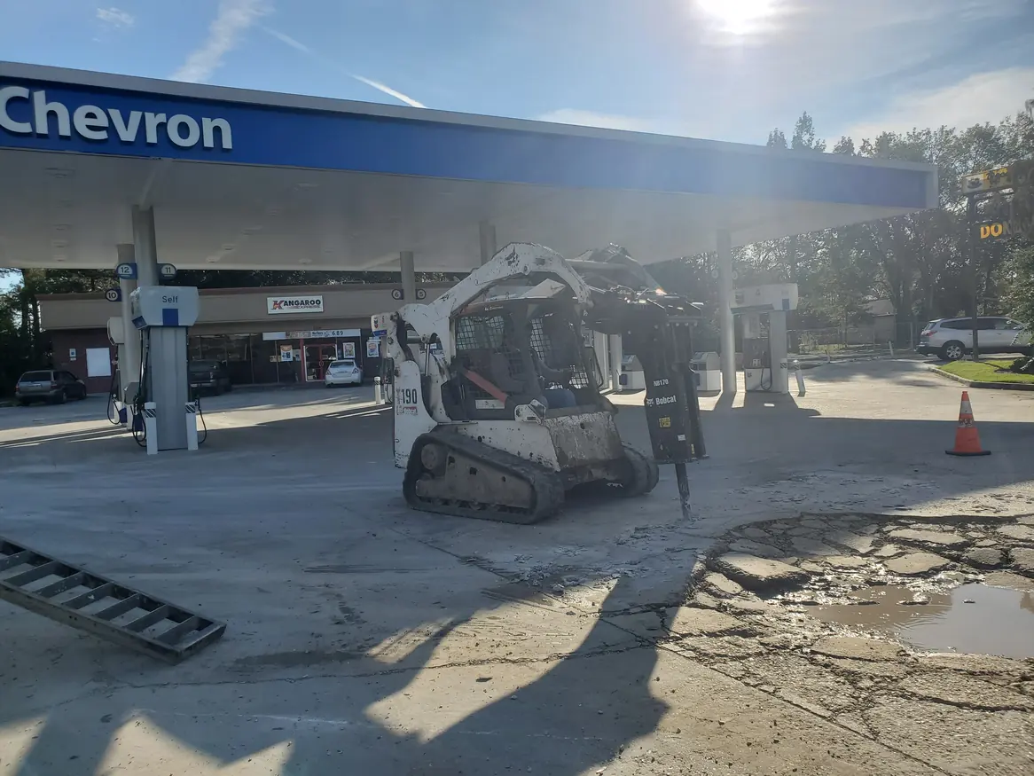 Loader removing pavement at a gas station